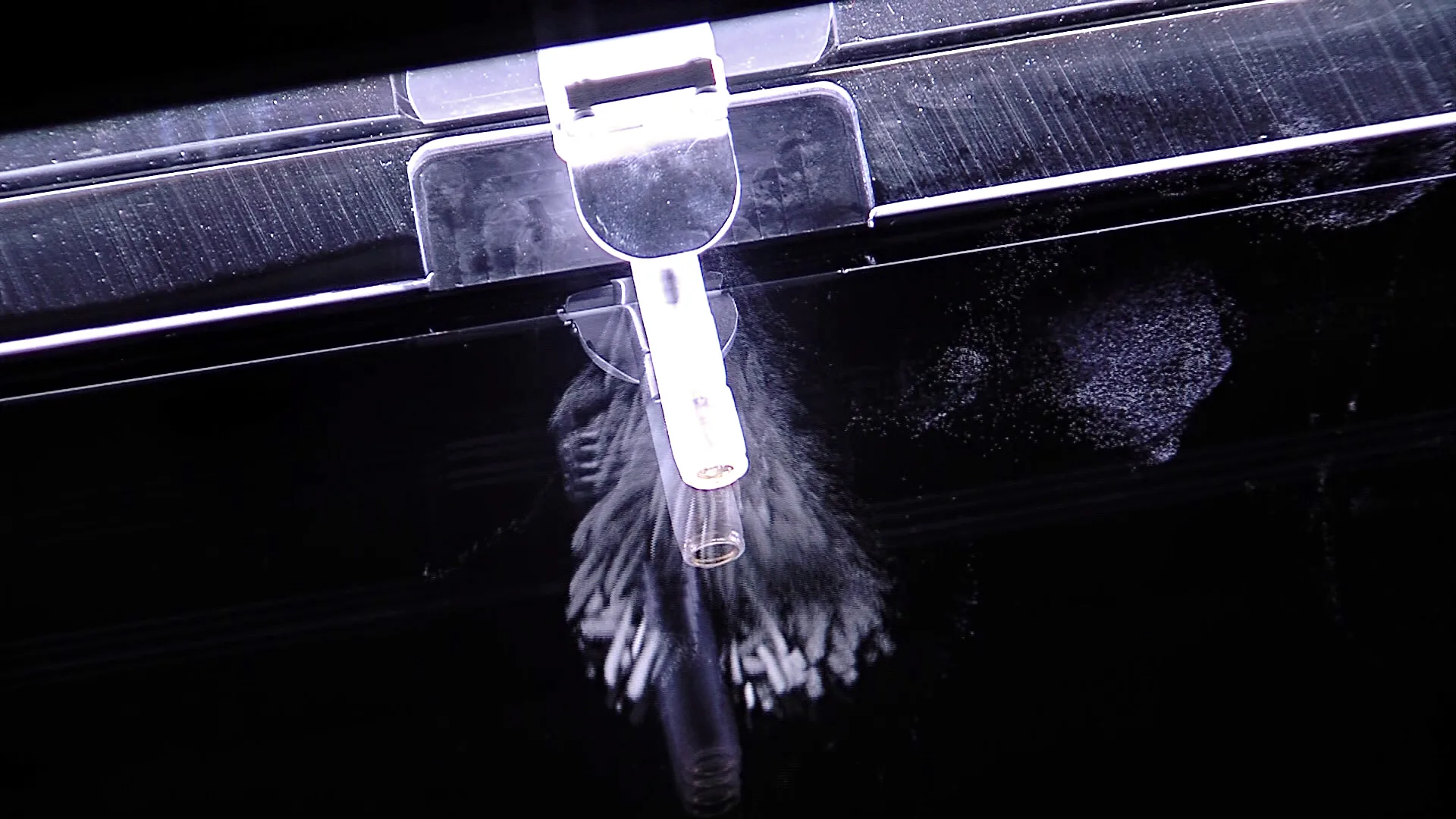 Americium-241 source emitting alpha particles inside a cloud chamber